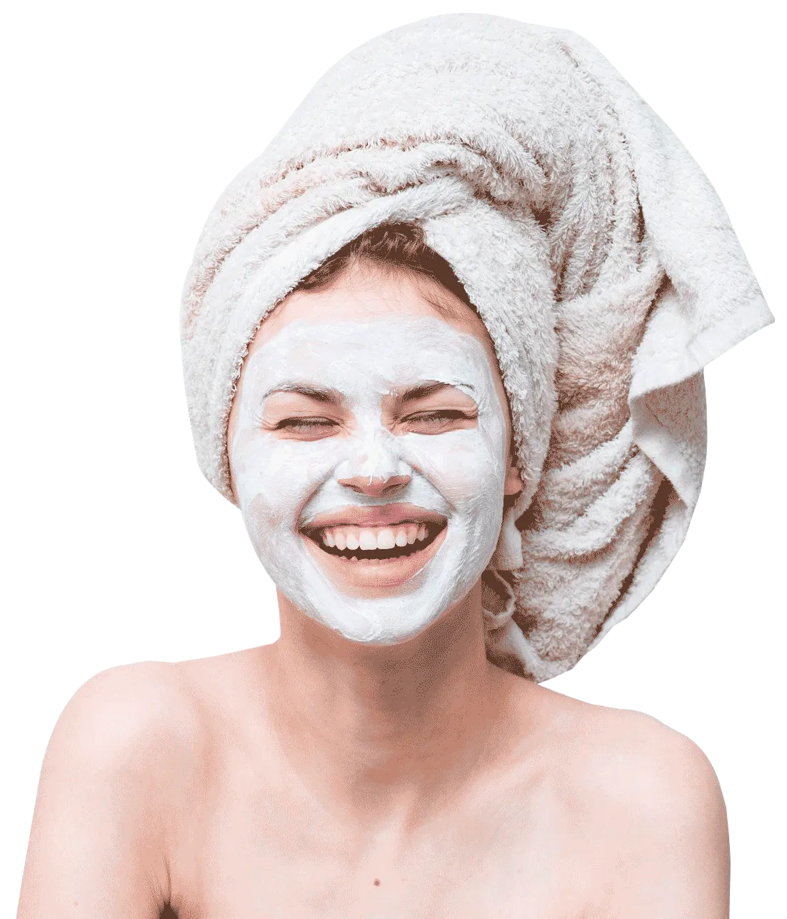 Smiling woman with hair in towel and with facial cream on face